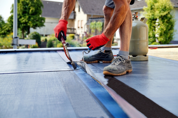 Working repairing a roof