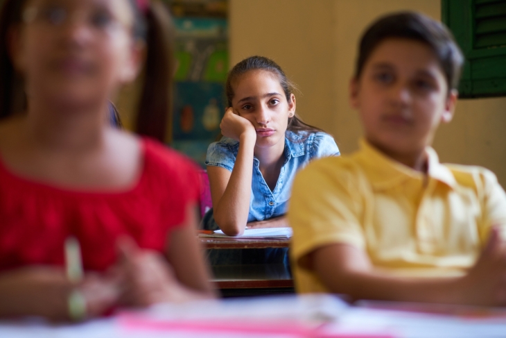 Bothered school student in a classroom