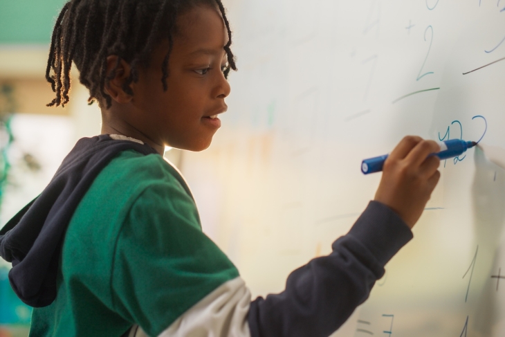 Student doing math in a classroom