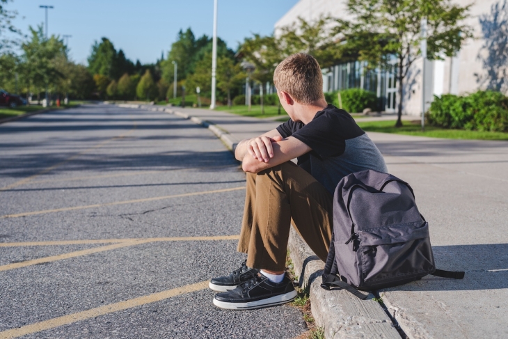 Student sitting alone outdoors