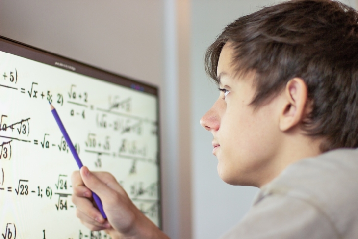 Teenage student doing math