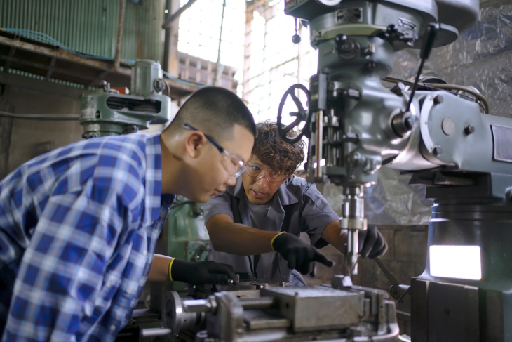 Students working on machine