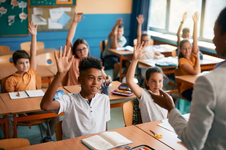 Students with hands raised