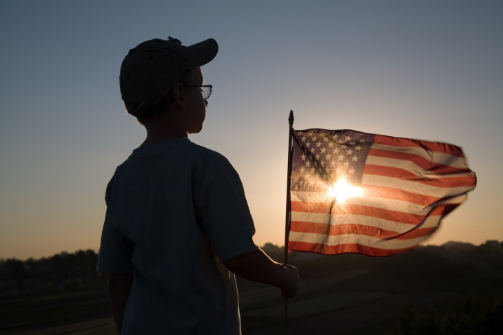 Child holding an American flag
