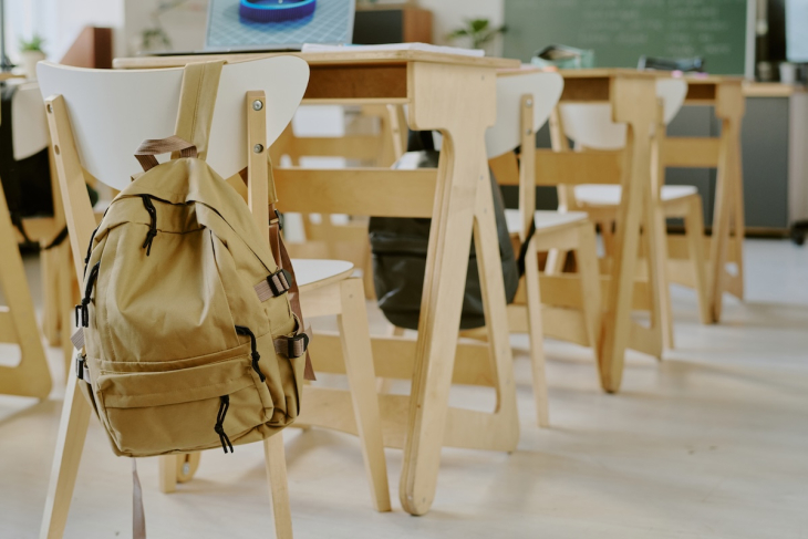 Empty desks with backpacks